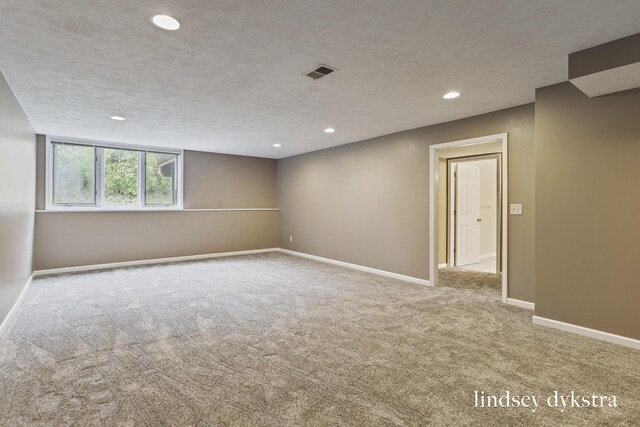 1013 Country Gdns NW, Walker, MI 49534 - carpeted spare room featuring visible vents, baseboards, and recessed lighting