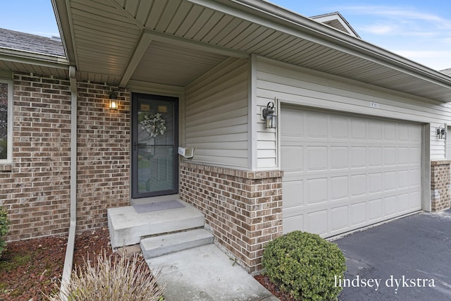 1013 Country Gdns NW, Walker, MI 49534 - property entrance with brick siding and aphalt driveway