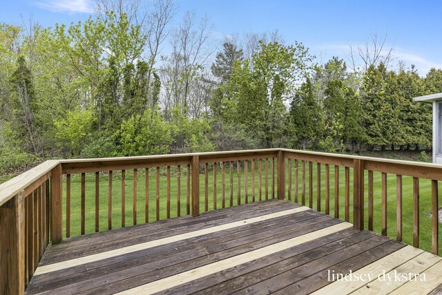 1013 Country Gdns NW, Walker, MI 49534 - wooden deck featuring a lawn