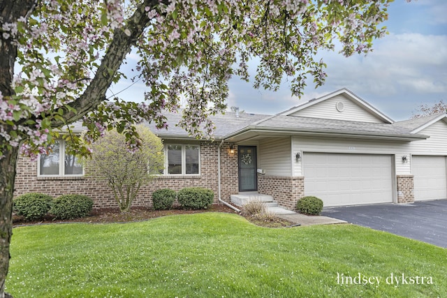 1013 Country Gdns NW, Walker, MI 49534 - ranch-style house featuring an attached garage, brick siding, a front yard, and aphalt driveway