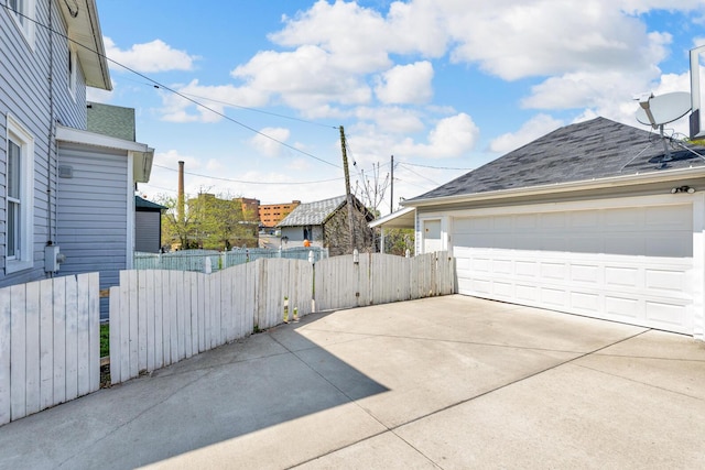 garage with fence and a gate