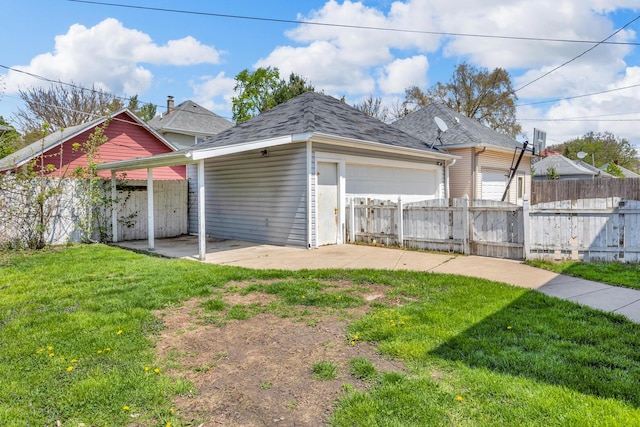 view of front facade featuring a shingled roof, a garage, fence, and a front yard