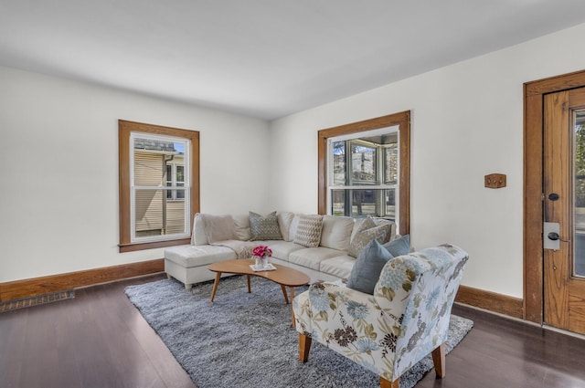 living room with a wealth of natural light, baseboards, and wood finished floors