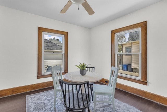 dining space with a wealth of natural light, baseboards, a ceiling fan, and wood finished floors