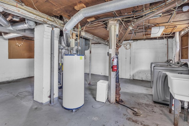 unfinished below grade area featuring independent washer and dryer and gas water heater
