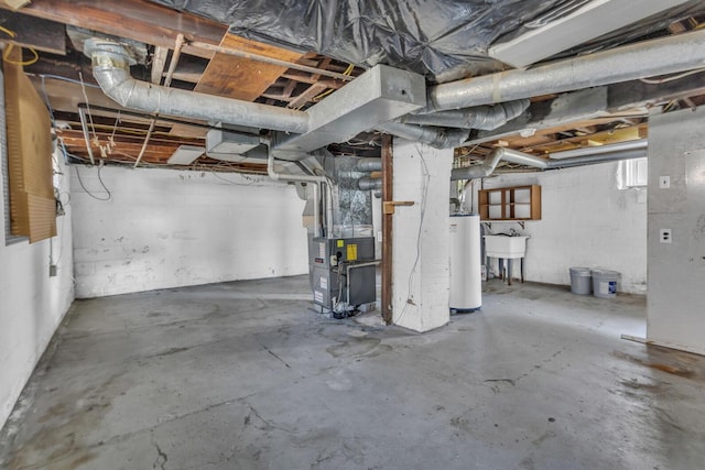 unfinished below grade area with heating unit, water heater, and a sink