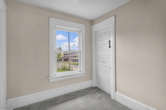 carpeted spare room with baseboards