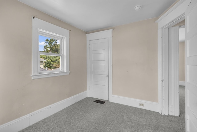 interior space featuring carpet flooring, baseboards, and visible vents