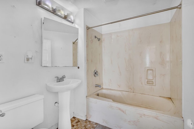 full bath featuring toilet, shower / bathing tub combination, and a sink