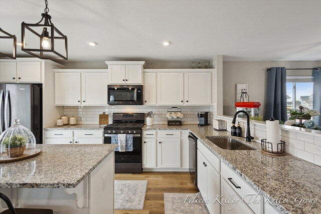 560 Pioneer Trl, Cedar Springs, MI 49319 - kitchen with a sink, stainless steel appliances, tasteful backsplash, and white cabinets