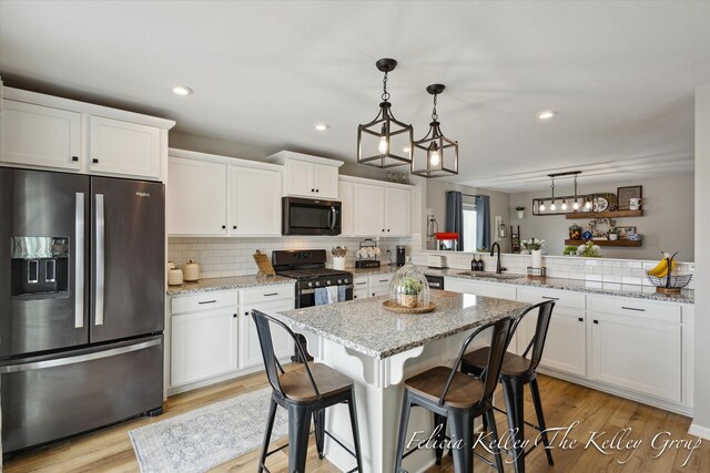 560 Pioneer Trl, Cedar Springs, MI 49319 - kitchen featuring backsplash, stainless steel appliances, white cabinets, and a sink
