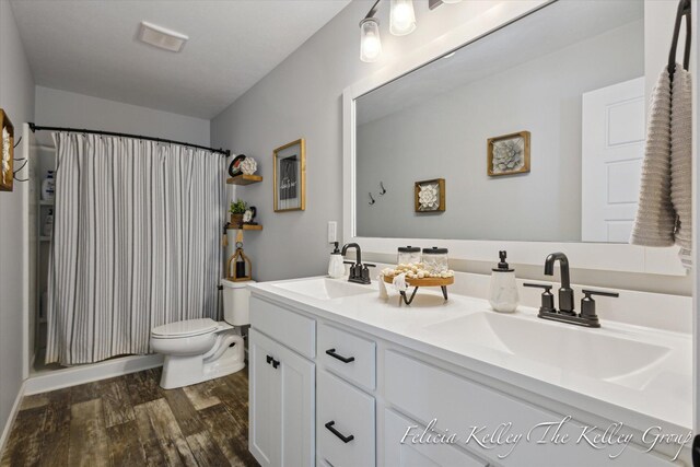 560 Pioneer Trl, Cedar Springs, MI 49319 - full bath featuring toilet, double vanity, a sink, and wood finished floors