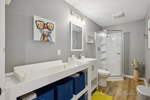 560 Pioneer Trl, Cedar Springs, MI 49319 - full bath with a stall shower, vanity, toilet, and wood finished floors