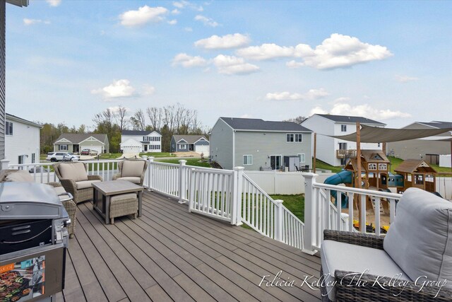 560 Pioneer Trl, Cedar Springs, MI 49319 - wooden deck with fence, area for grilling, a residential view, an outdoor hangout area, and a playground