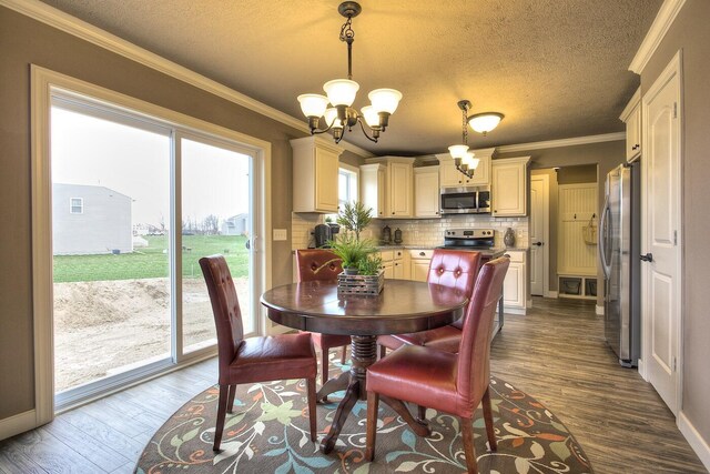 5672 Landrum Trl, Portage, MI 49024 - dining space featuring a chandelier, dark wood-style flooring, a textured ceiling, ornamental molding, and baseboards