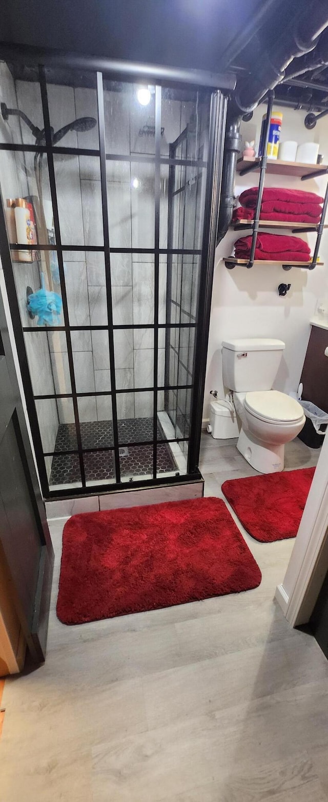 3550 Oak St, Hudsonville, MI 49426 - full bathroom with a shower stall, toilet, and wood finished floors