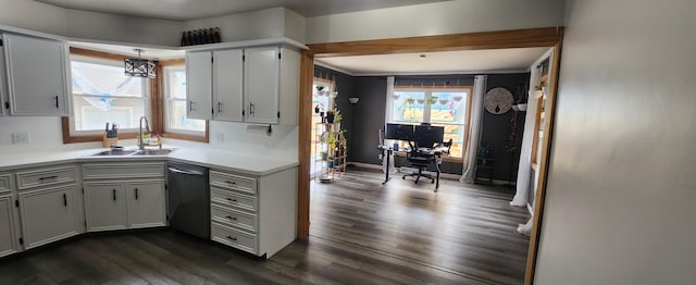 3550 Oak St, Hudsonville, MI 49426 - kitchen with stainless steel dishwasher, a sink, dark wood-style flooring, light countertops, and a desk