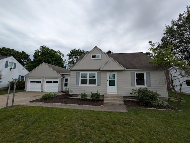 3550 Oak St, Hudsonville, MI 49426 - bungalow-style home featuring a detached garage, a front yard, board and batten siding, an outdoor structure, and a shingled roof
