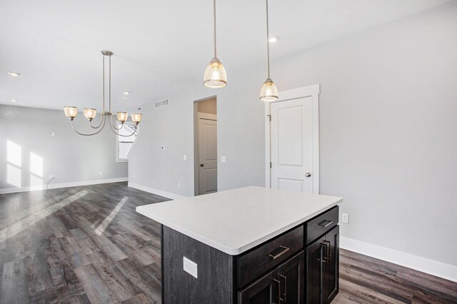 8851 Loggers Ridge Ct SE, Caledonia, MI 49316 - kitchen featuring baseboards, visible vents, dark wood-style flooring, light countertops, and a kitchen island