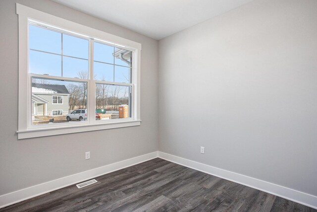 8851 Loggers Ridge Ct SE, Caledonia, MI 49316 - spare room featuring baseboards, visible vents, and dark wood finished floors