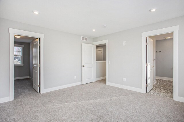 8851 Loggers Ridge Ct SE, Caledonia, MI 49316 - unfurnished bedroom with light carpet, baseboards, visible vents, and recessed lighting