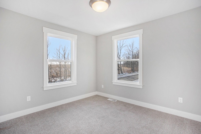 8851 Loggers Ridge Ct SE, Caledonia, MI 49316 - unfurnished room featuring a wealth of natural light, carpet, baseboards, and visible vents