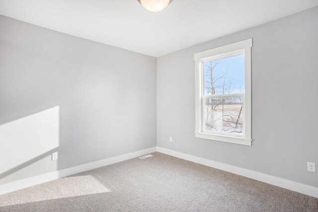 8851 Loggers Ridge Ct SE, Caledonia, MI 49316 - carpeted spare room featuring baseboards and visible vents