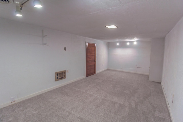 finished below grade area featuring baseboards, visible vents, and carpet floors