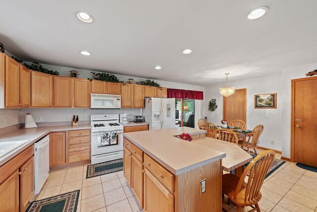 5521 W Spring Creek Rd, Three Oaks, MI 49128 - kitchen featuring white appliances, a kitchen bar, light tile patterned floors, a chandelier, and recessed lighting
