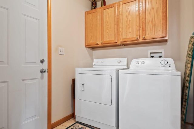 5521 W Spring Creek Rd, Three Oaks, MI 49128 - washroom featuring cabinet space, washing machine and clothes dryer, light tile patterned flooring, and baseboards