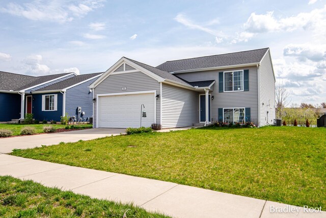 8161 W Sturtevant Ave, Richland, MI 49083 - view of front of house featuring an attached garage, concrete driveway, a front yard, and cooling unit
