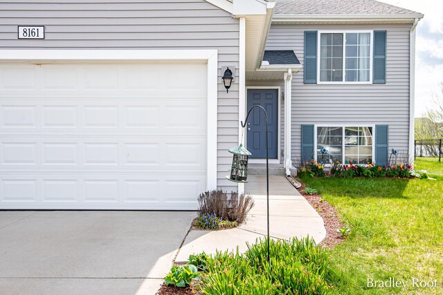 8161 W Sturtevant Ave, Richland, MI 49083 - view of front of home with driveway, a front yard, a shingled roof, and a garage