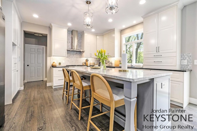 3673 Hunters Way Dr SE, Ada, MI 49301 - kitchen featuring wall chimney range hood, white cabinetry, decorative backsplash, and recessed lighting
