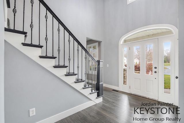 3673 Hunters Way Dr SE, Ada, MI 49301 - entryway with wood finished floors, baseboards, stairs, and a towering ceiling