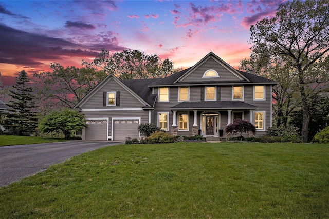 3673 Hunters Way Dr SE, Ada, MI 49301 - view of front of home with asphalt driveway, a garage, a yard, covered porch, and a shingled roof