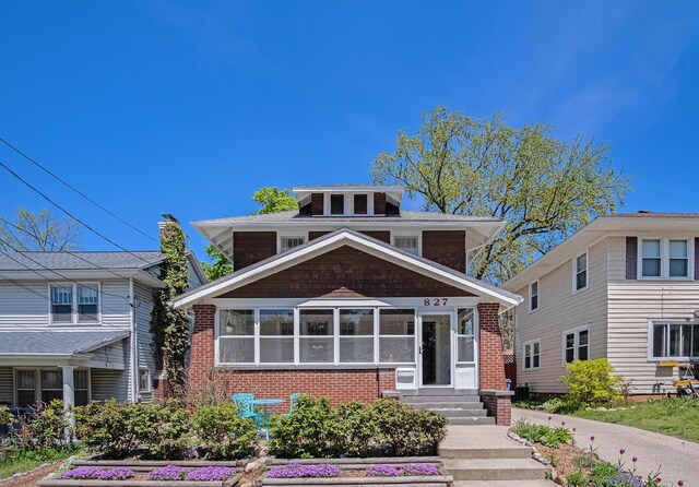 traditional style home featuring brick siding and entry steps