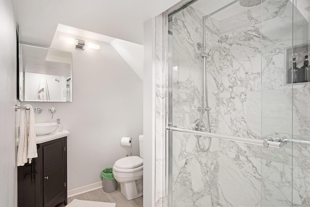 bathroom featuring toilet, a marble finish shower, and vanity