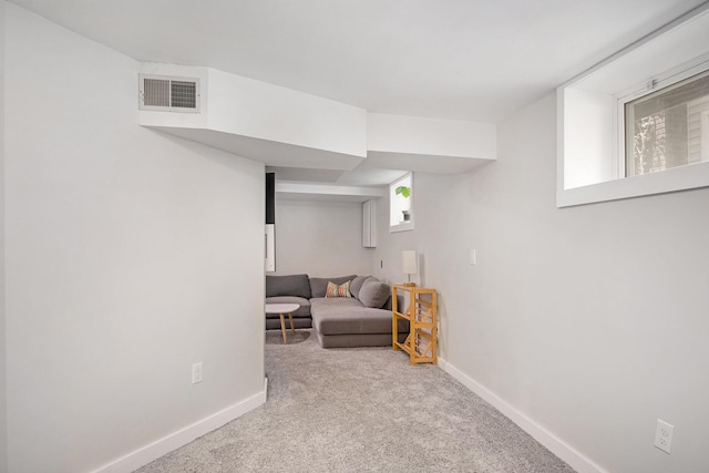 below grade area featuring carpet floors, baseboards, and healthy amount of natural light