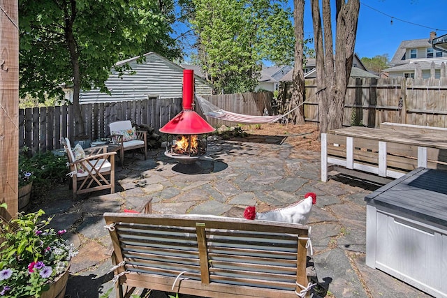 view of patio featuring a fire pit and a fenced backyard