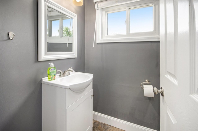 bathroom with plenty of natural light, vanity, and baseboards