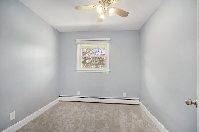 carpeted spare room featuring a baseboard heating unit, baseboards, and a ceiling fan