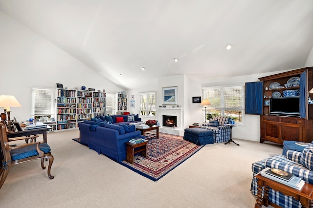 50102 Alpine Blvd, New Buffalo, MI 49117 - carpeted living area featuring a warm lit fireplace, high vaulted ceiling, and recessed lighting