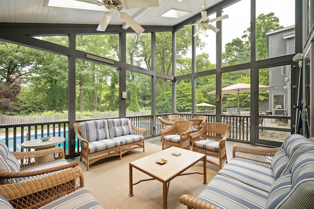 50102 Alpine Blvd, New Buffalo, MI 49117 - sunroom featuring ceiling fan, a skylight, and an outdoor living space