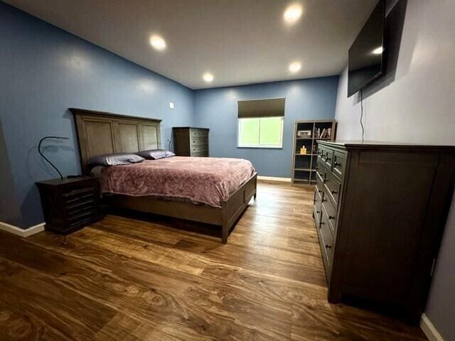 bedroom featuring baseboards, dark wood-type flooring, and recessed lighting