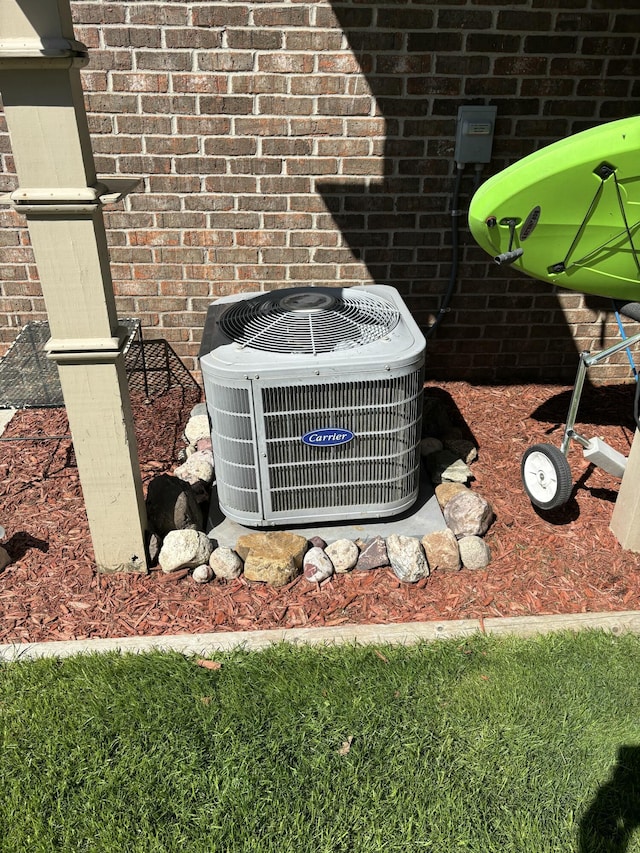 exterior view of central air condition unit and brick siding