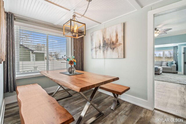 1520 Beach St, Muskegon, MI 49441 - dining area featuring wood finished floors, a chandelier, baseboards, and a ceiling fan