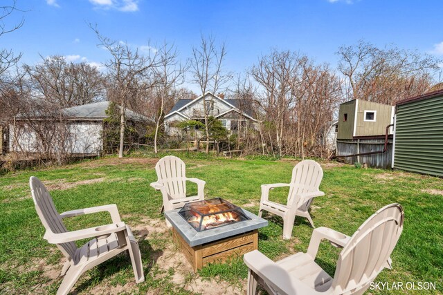 1520 Beach St, Muskegon, MI 49441 - view of green lawn with a fire pit and an outdoor structure
