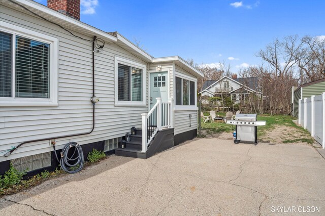 1520 Beach St, Muskegon, MI 49441 - view of home's exterior featuring a patio area, a chimney, and fence