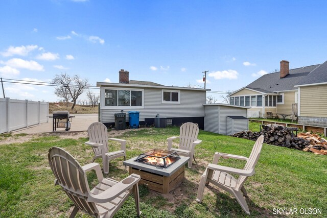 1520 Beach St, Muskegon, MI 49441 - rear view of property with a fire pit, a chimney, and central air condition unit
