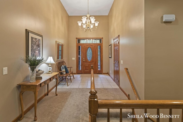 903 10 Mile Rd NW, Sparta, MI 49345 - tiled entryway featuring a towering ceiling, a chandelier, carpet, and baseboards